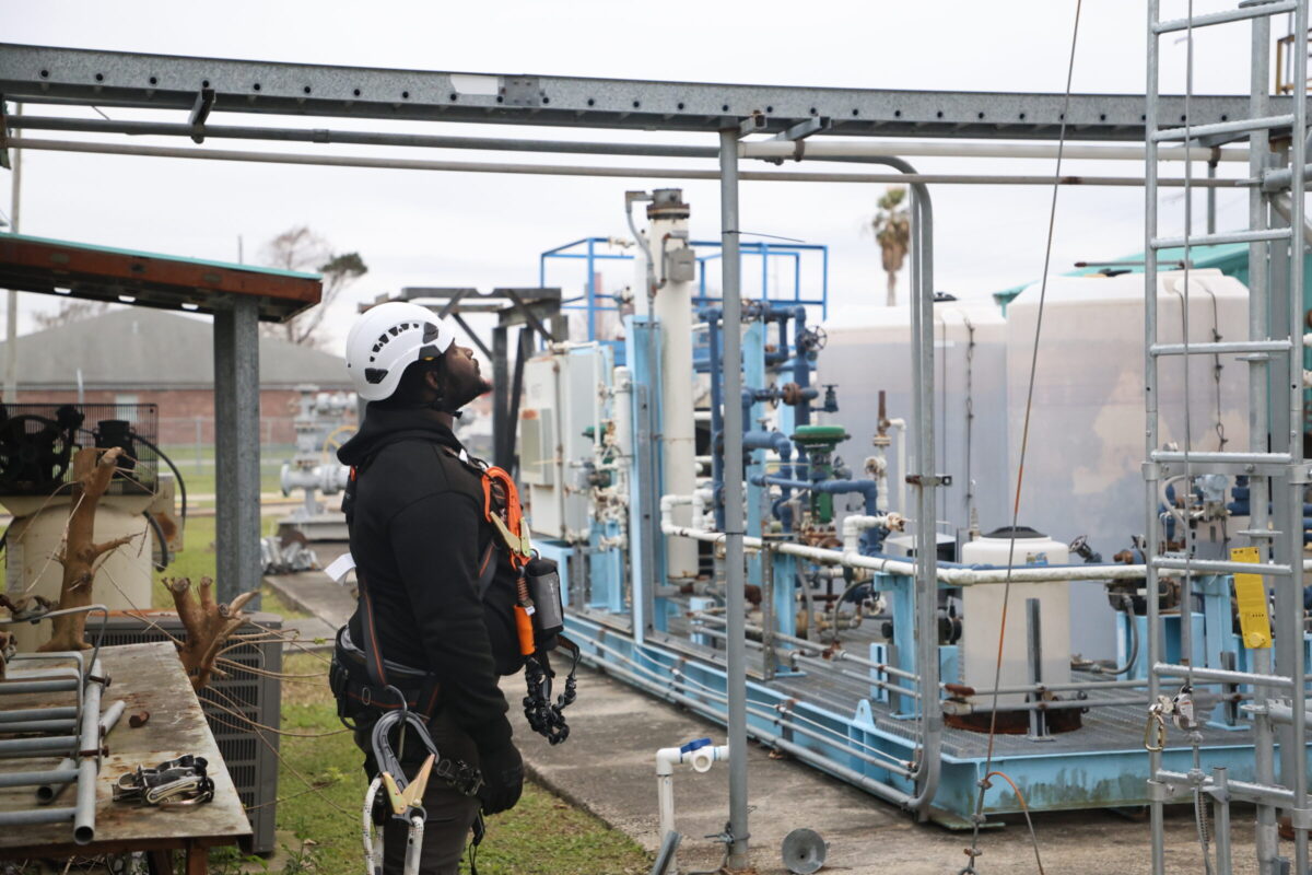 Cedrick Williams, a first-year student at Nunez Community College's wind energy degree program prepares to climb a practice scaffold on Friday, February 14.