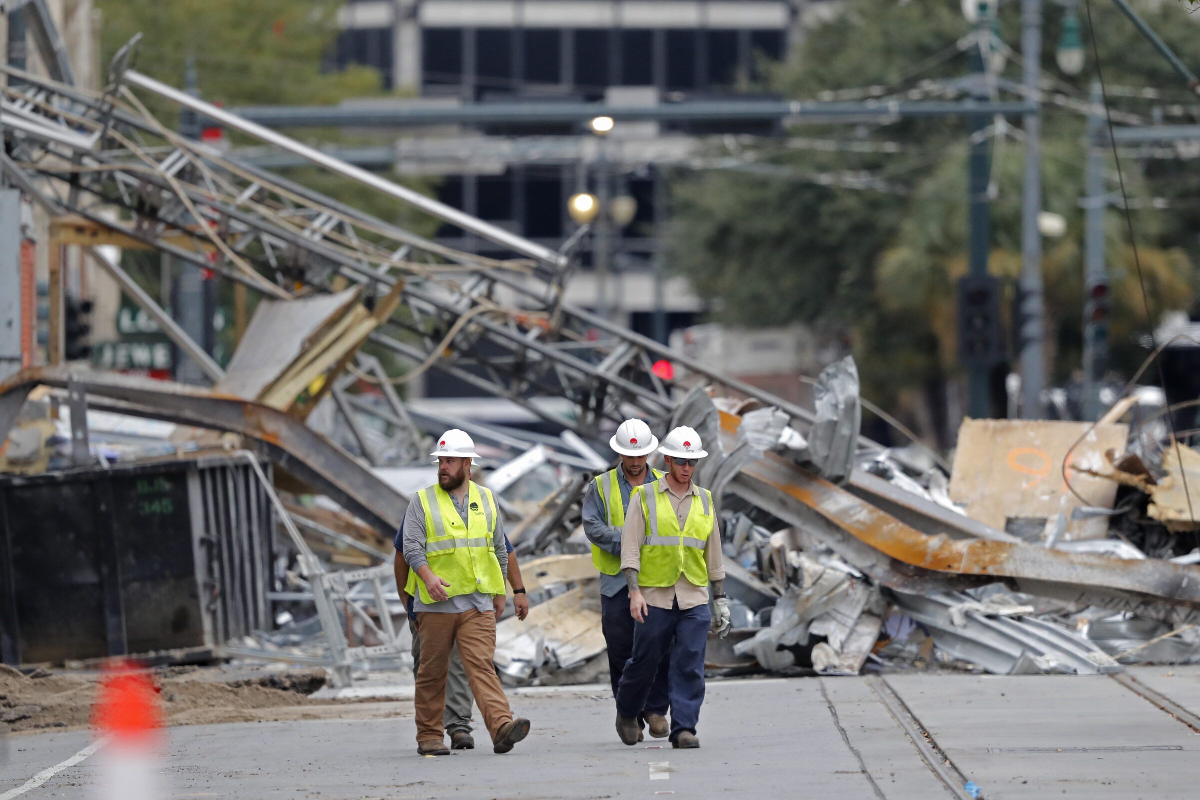 Workers walk from the site of the Hard Rock Hotel in New Orleans, Wednesday, Oct. 16, 2019. New Orleans officials say the chances of a missing worker's survival after the collapse are diminishing, and they have shifted their efforts from rescue to recovery mode. News outlets report Fire Department Superintendent Tim McConnell says they shifted Wednesday ahead of a possible tropical storm. McConnell says chances of the missing worker's survival will be considered nearly "zero" if no sign of him turns up by Wednesday night.