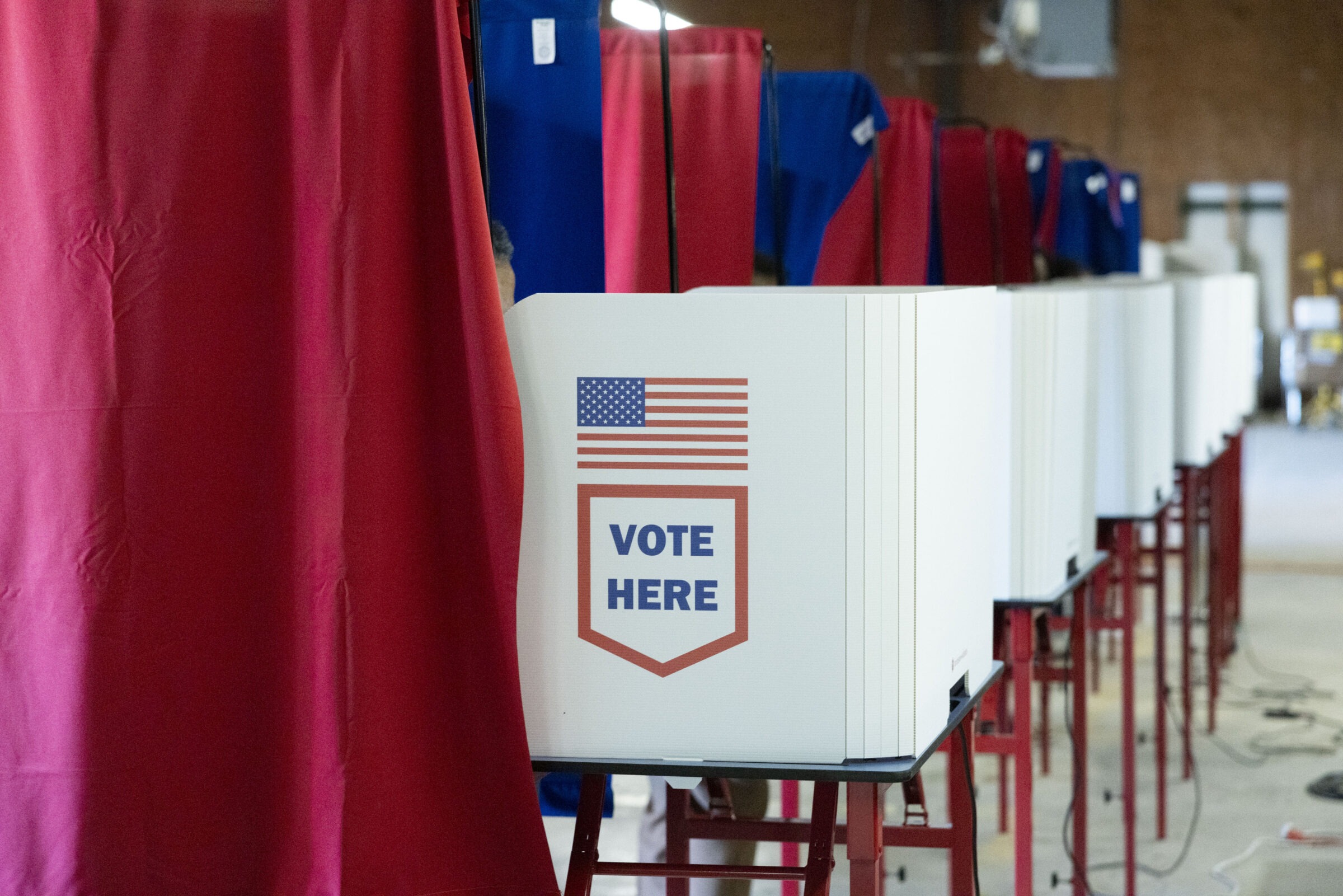 Voting machines with privacy curtains at the Voting Machine Warehouse in New Orleans East on the first day of early voting on Saturday, September 27, 2025. Voters are headed out to the polls on Oct. 11 for Election Day in New Orleans.